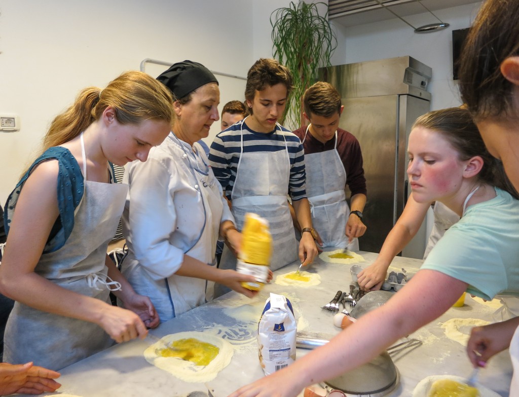 Marchella, our cooking instructor, swoops in for some instruction